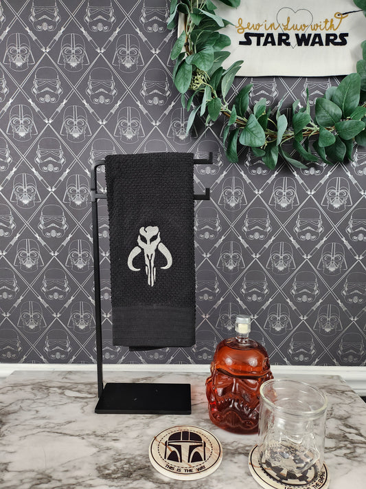 Mandolorian  Mythosaur inspired embroidered on a black Kitchen Towel